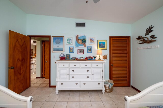 tiled bedroom with ceiling fan