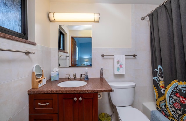 full bathroom featuring vanity, tile walls, shower / bath combo, and toilet