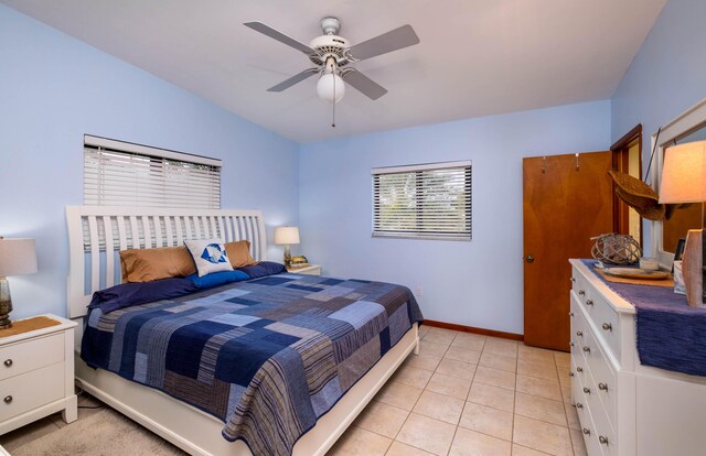 tiled bedroom featuring ceiling fan