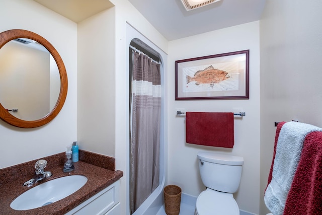 bathroom with vanity, curtained shower, and toilet