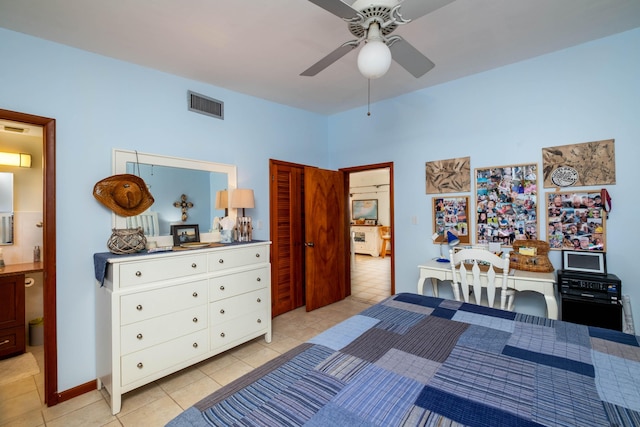 bedroom with ceiling fan, connected bathroom, and light tile patterned floors