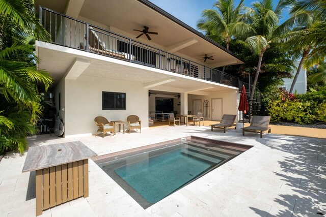 back of house featuring ceiling fan, a patio area, and a balcony