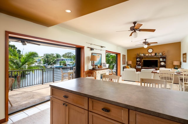 kitchen with light tile patterned floors and a water view