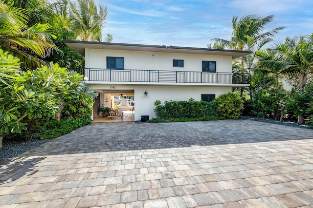 rear view of property with a balcony