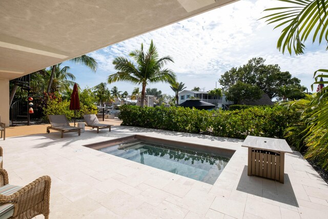 view of pool featuring a hot tub and a patio