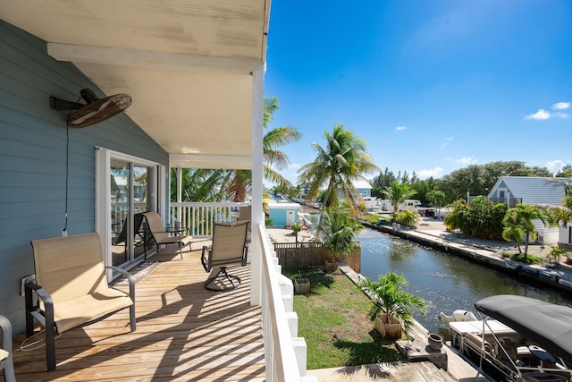 exterior space with a water view and ceiling fan