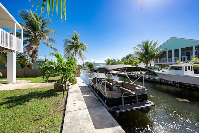 dock area with a water view and a lawn