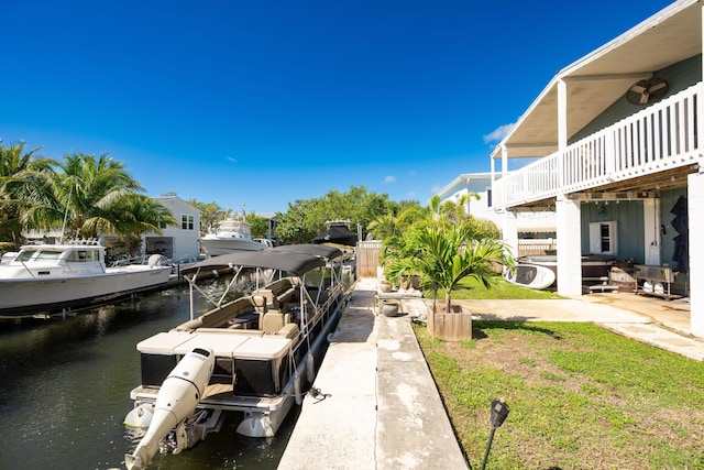 exterior space with a water view and a boat dock