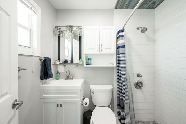 bathroom with vanity, toilet, and walk in shower