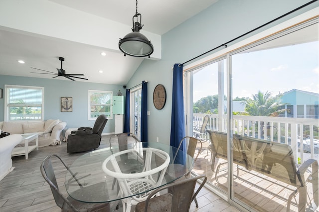 dining room with ceiling fan, plenty of natural light, lofted ceiling, and light wood-type flooring