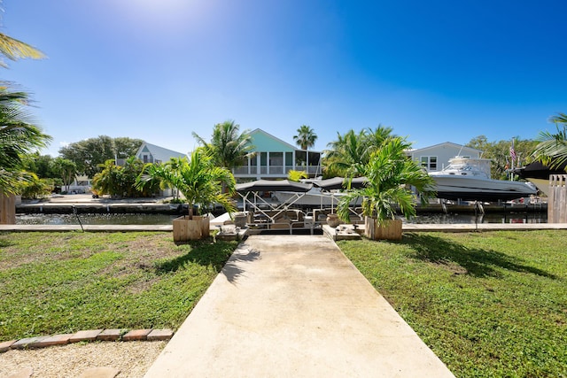 view of property's community with a water view and a yard