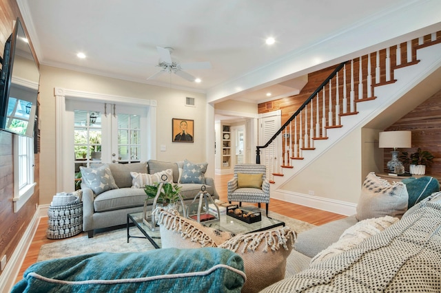 living room featuring french doors, crown molding, ceiling fan, and light hardwood / wood-style flooring