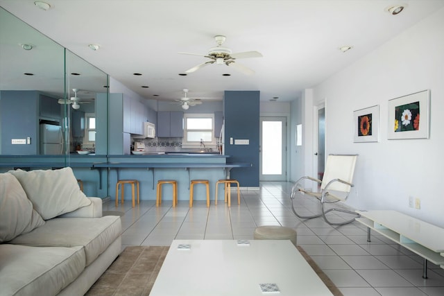 living room with light tile patterned flooring and ceiling fan