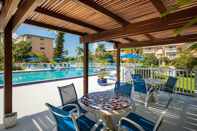 view of patio featuring a community pool and a pergola