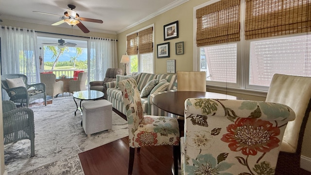 dining area featuring crown molding, ceiling fan, and hardwood / wood-style flooring