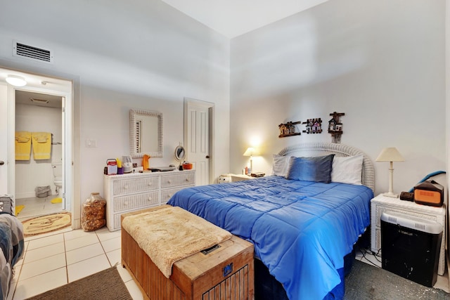 bedroom with a high ceiling, tile patterned flooring, and visible vents