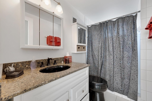 full bathroom featuring toilet, vanity, a shower with shower curtain, and tile patterned floors