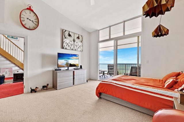 carpeted bedroom with access to exterior, baseboards, and high vaulted ceiling