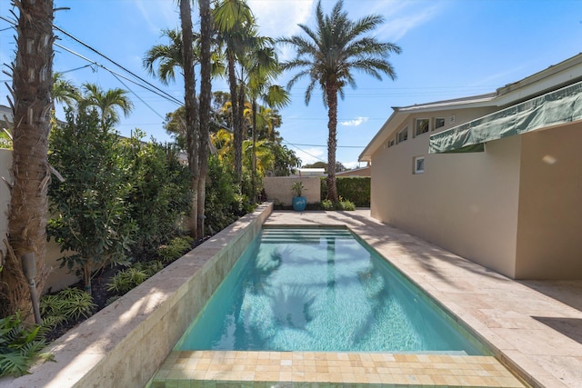 view of swimming pool with a fenced backyard, a fenced in pool, and a patio