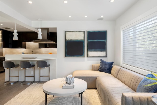 living area featuring wood finished floors and recessed lighting