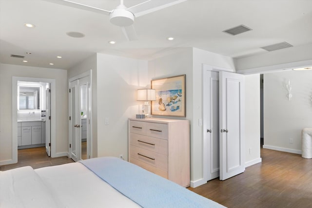 bedroom with baseboards, visible vents, dark wood finished floors, and recessed lighting