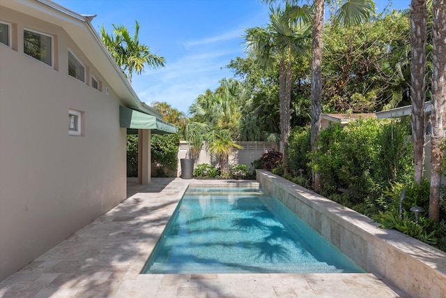 view of swimming pool featuring a patio area, a fenced backyard, and a fenced in pool