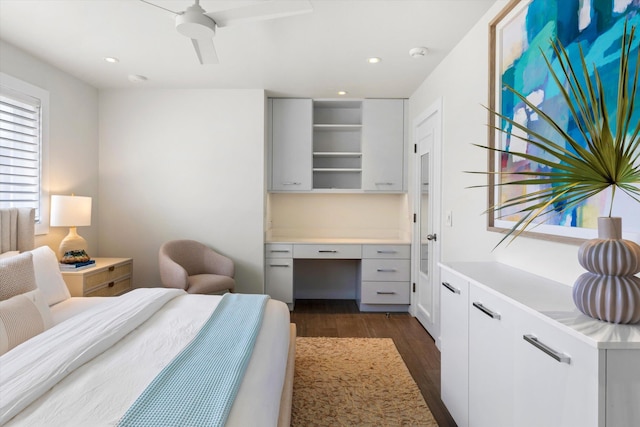 bedroom featuring recessed lighting, dark wood-style flooring, built in study area, and ceiling fan