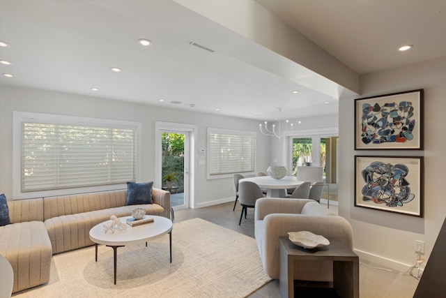 living area featuring light wood-style flooring, baseboards, and recessed lighting