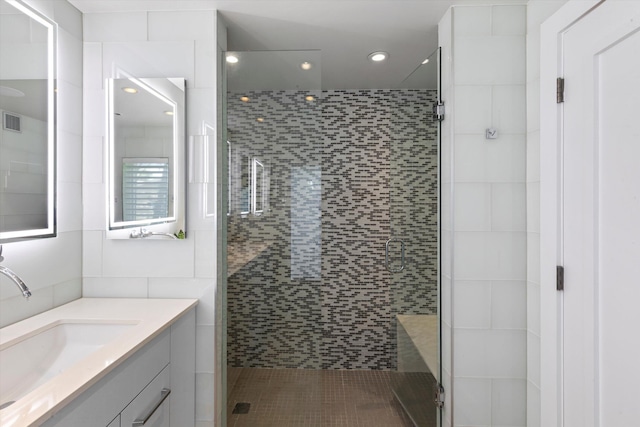 bathroom featuring recessed lighting, visible vents, a shower stall, and vanity