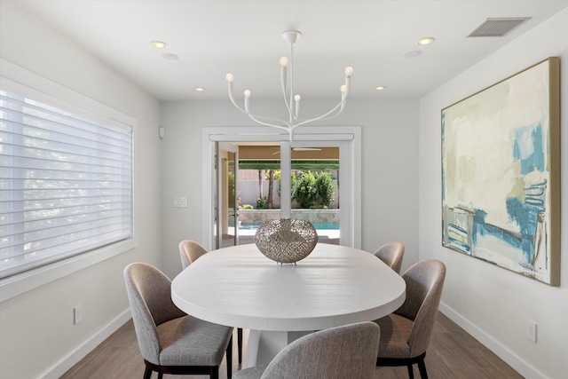 dining space with recessed lighting, visible vents, baseboards, and wood finished floors