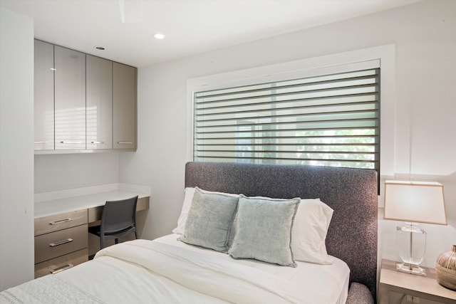 bedroom with built in desk and recessed lighting