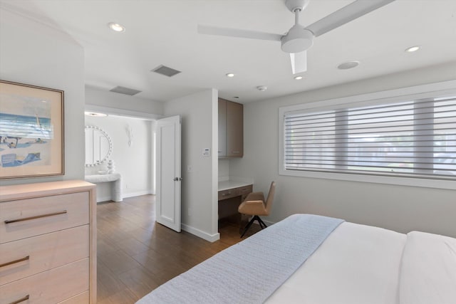 bedroom featuring recessed lighting, dark wood-style flooring, visible vents, and built in desk