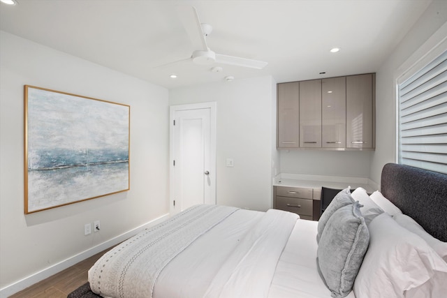 bedroom featuring baseboards, built in desk, wood finished floors, and recessed lighting