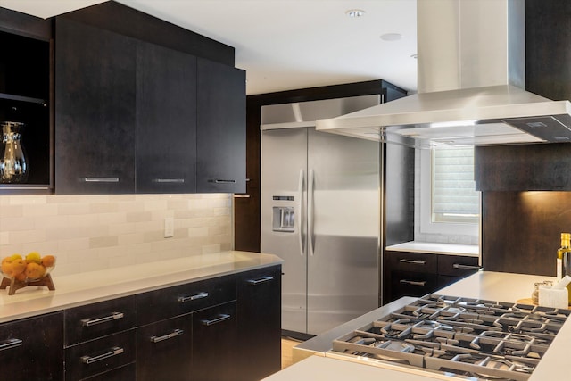 kitchen with stainless steel appliances, tasteful backsplash, light countertops, island range hood, and modern cabinets