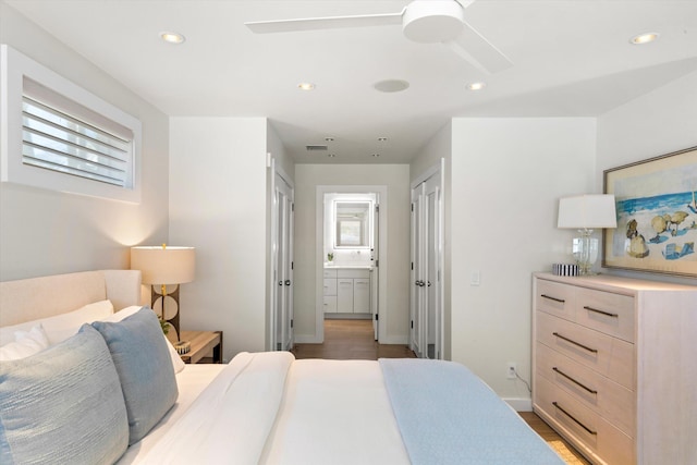 bedroom with recessed lighting, multiple windows, and wood finished floors