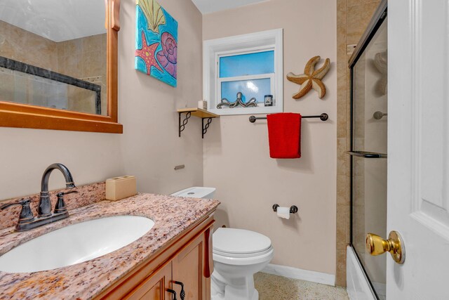 full bathroom featuring enclosed tub / shower combo, vanity, and toilet