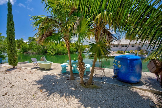 view of yard featuring a water view and a patio area