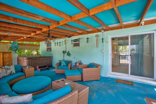 view of patio / terrace with a hot tub and an outdoor living space