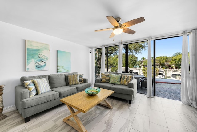 living room with floor to ceiling windows and a ceiling fan