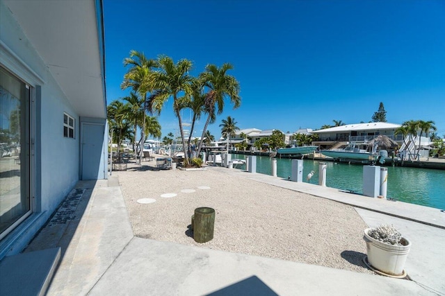 view of patio / terrace with a water view and a dock