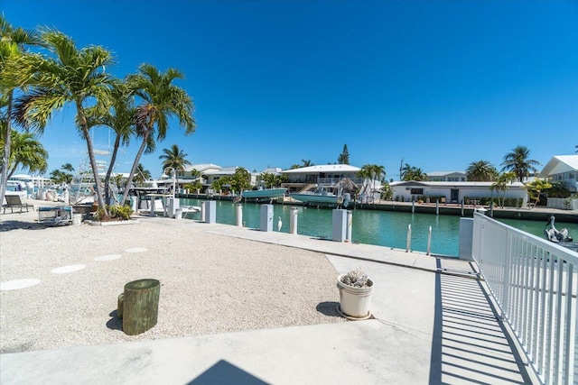 view of swimming pool with a water view and a boat dock