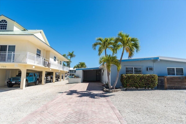 view of front facade featuring a carport and decorative driveway