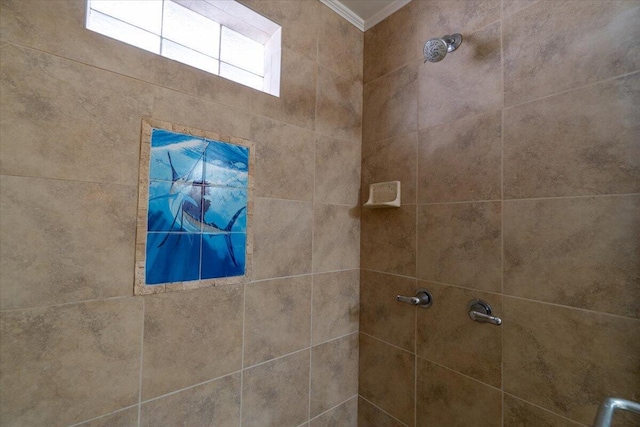 bathroom featuring crown molding and a tile shower