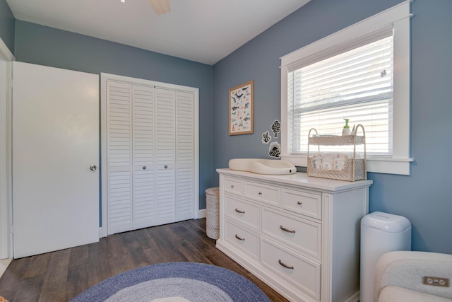 bedroom featuring a closet, dark wood finished floors, and a ceiling fan