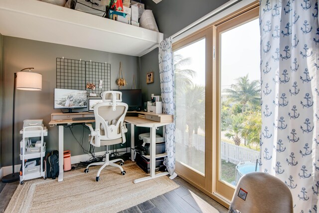 home office with baseboards and wood finished floors