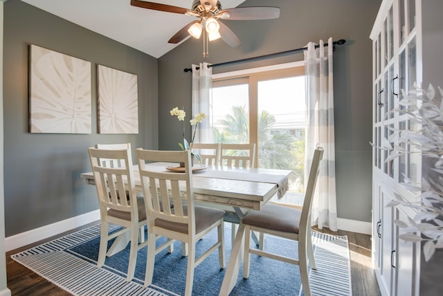 dining area featuring vaulted ceiling, wood finished floors, baseboards, and ceiling fan