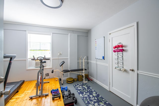 exercise area featuring a textured ceiling