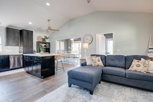 living room with high vaulted ceiling, recessed lighting, a ceiling fan, and light wood-style floors