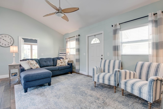 living area featuring vaulted ceiling, baseboards, a ceiling fan, and wood finished floors