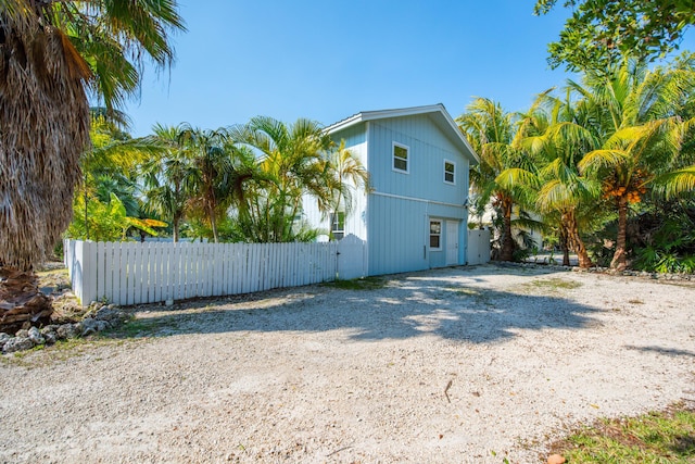 view of side of home featuring fence